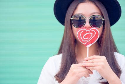 Heart shaped lollipop and a cool hipster woman