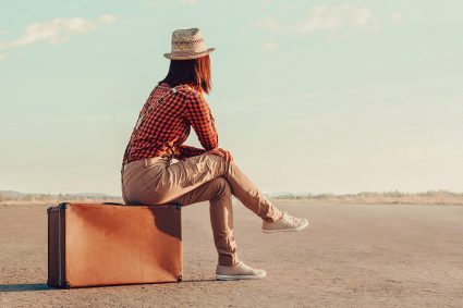 Traveling woman on suitcase