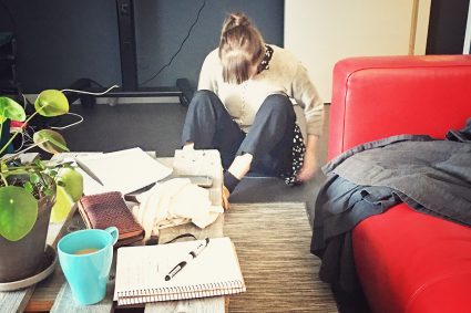 Amalia sitter på golvet och testar material till Heather