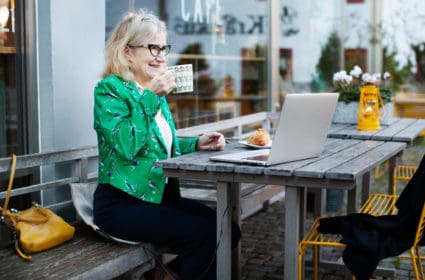Woman sitting on a Heather at a cafe