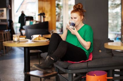 Woman sitting on a Heather at a cafe
