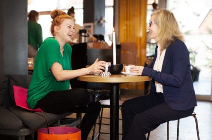 Woman sitting on a Heather at a cafe