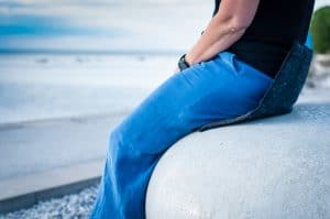 A woman sitting on the heated pad Heather with an amazing view over the Baltic sea.
