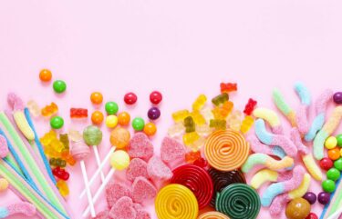 Colorful candy and fruit jelly jujube on a pink background